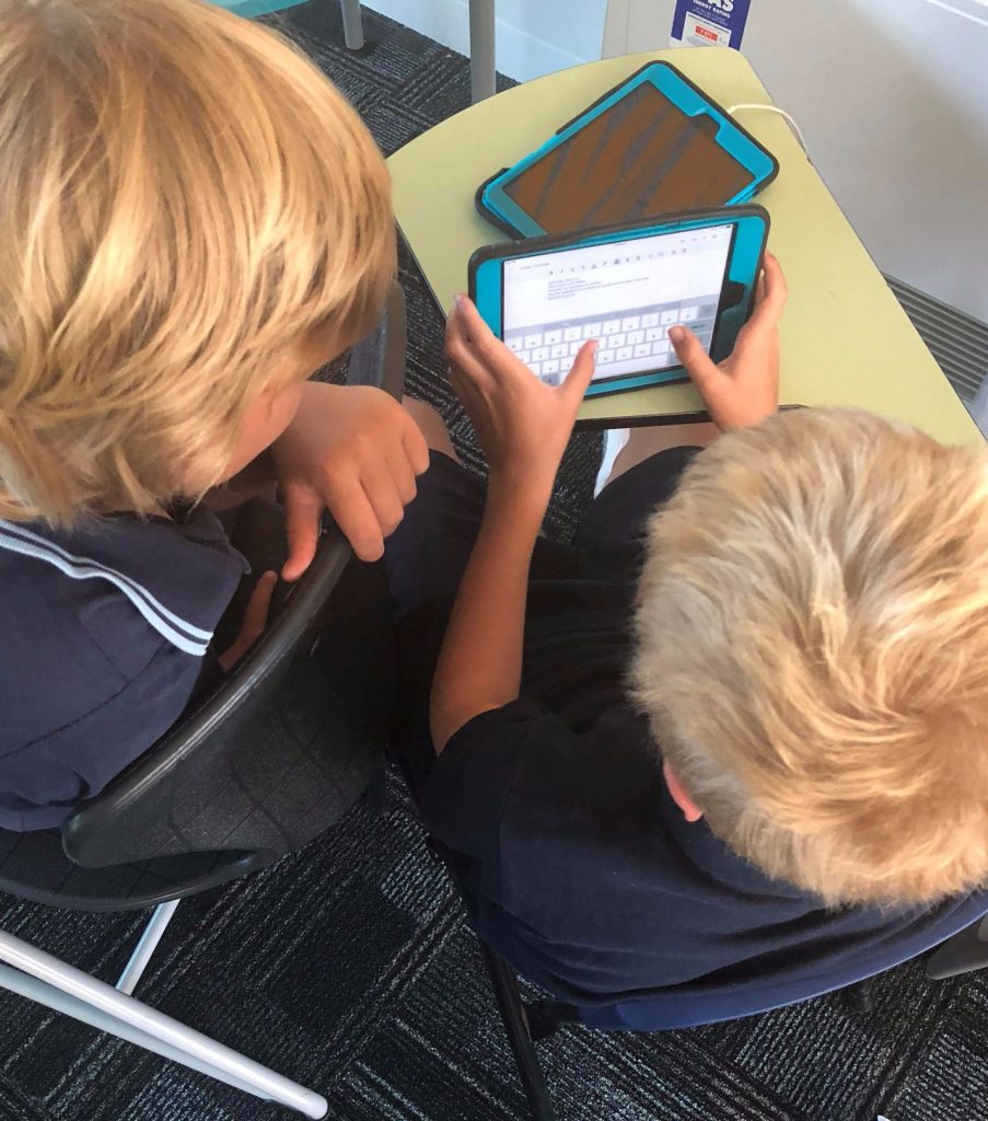 Students working together on an ipad